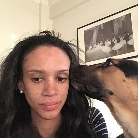 A picture of AjaBleu Oldham with her pet dog Miles.